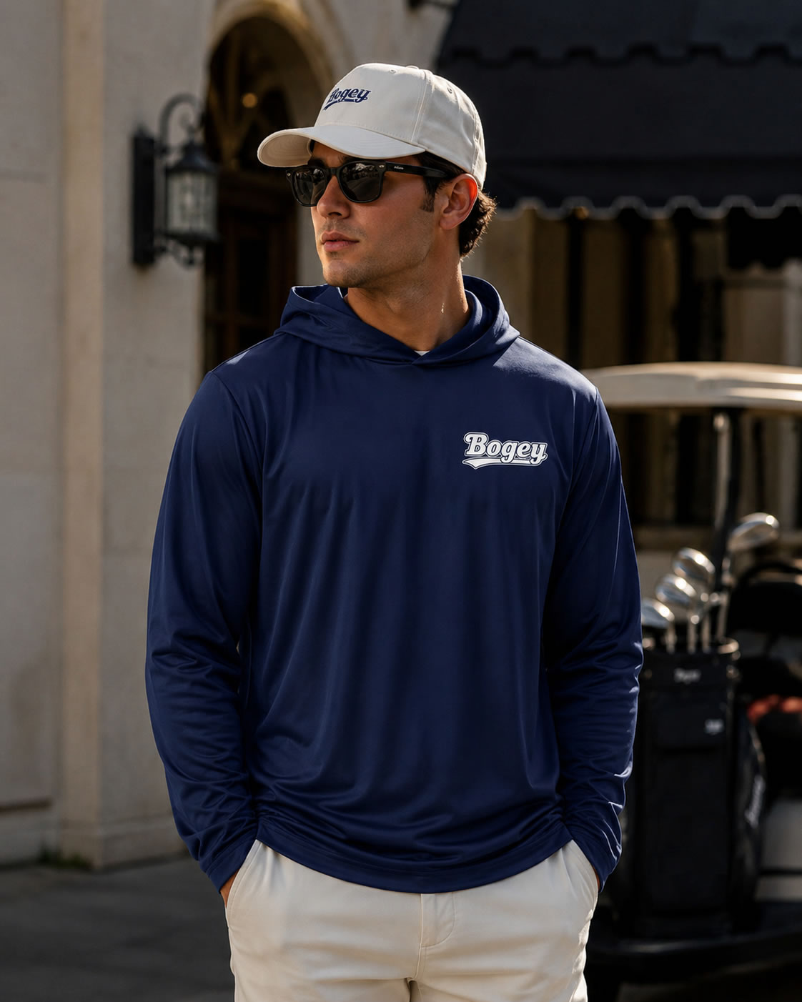 Model wearing navy blue bogey performance golf hoodie for men