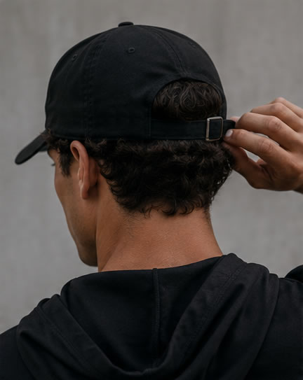 man wearing black adjustable golf dad hat