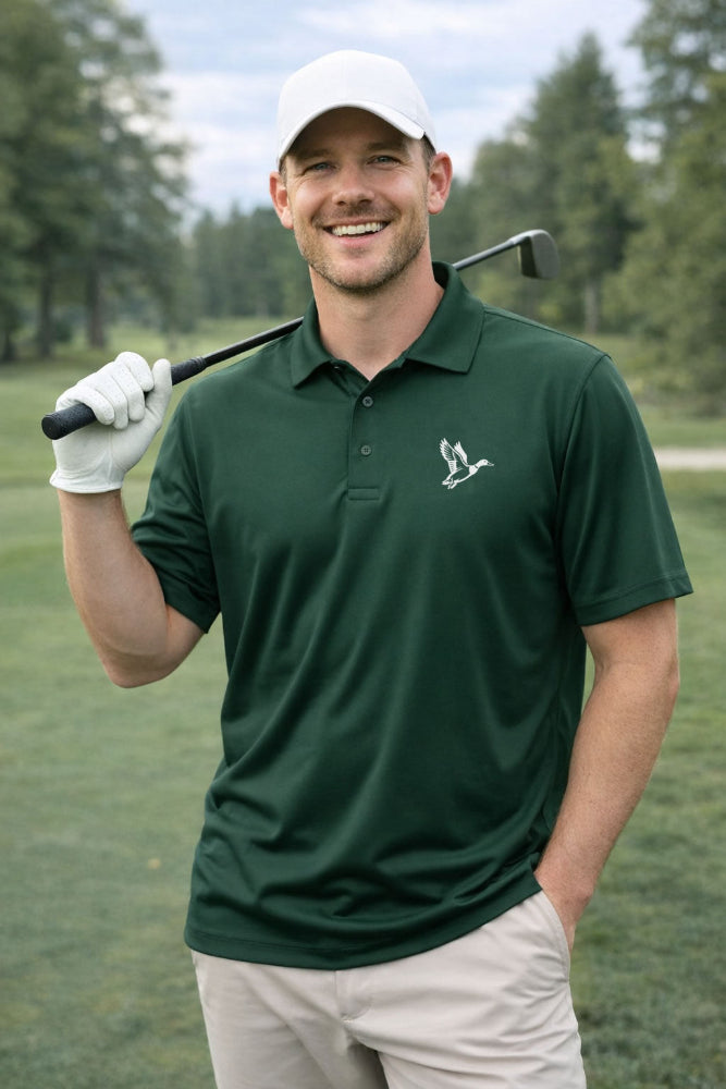 Man in green mallard duck golf polo shirt holding a golf club on a golf course